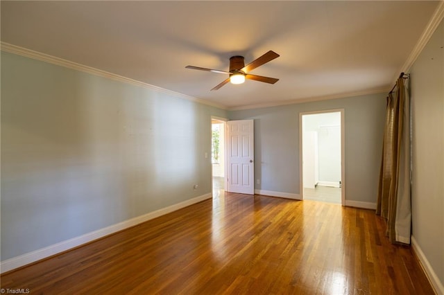 spare room with ceiling fan, dark hardwood / wood-style floors, and crown molding