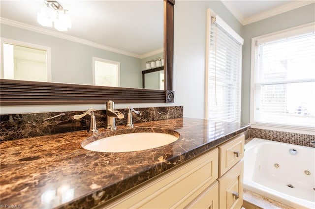 bathroom with a bathing tub, ornamental molding, and vanity