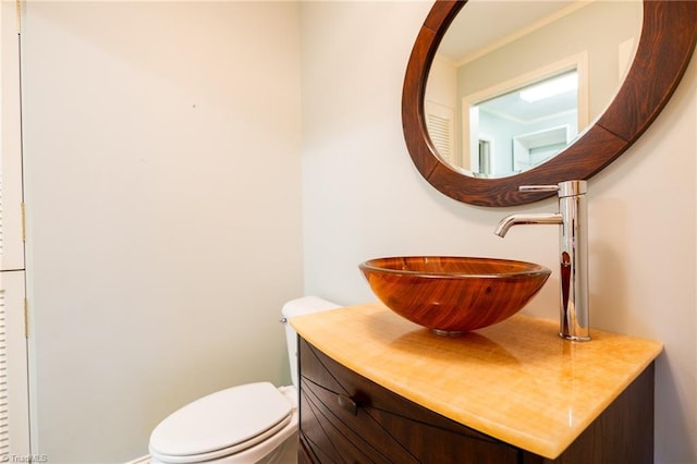 bathroom featuring toilet and vanity