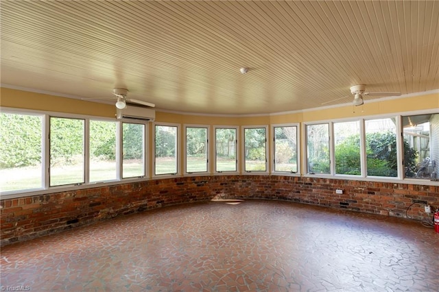 unfurnished sunroom with ceiling fan and a wall mounted AC