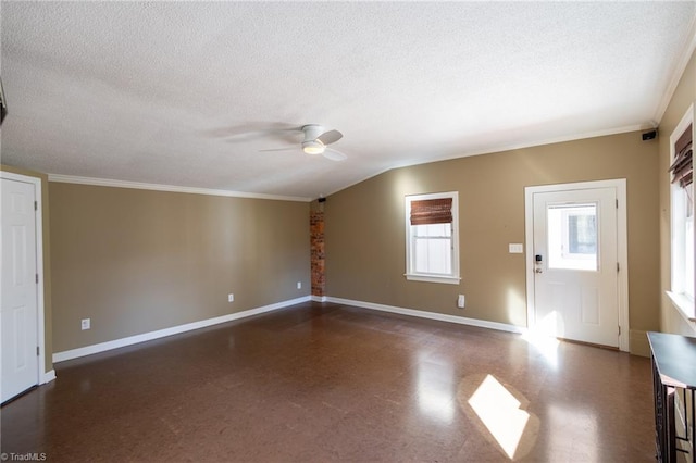 interior space featuring ceiling fan, lofted ceiling, ornamental molding, and a textured ceiling