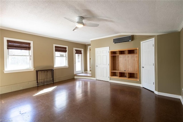 interior space with an AC wall unit, a textured ceiling, crown molding, and ceiling fan