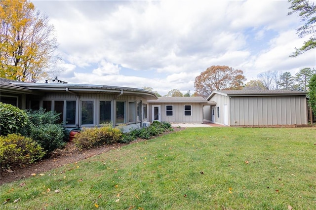 rear view of house with a yard