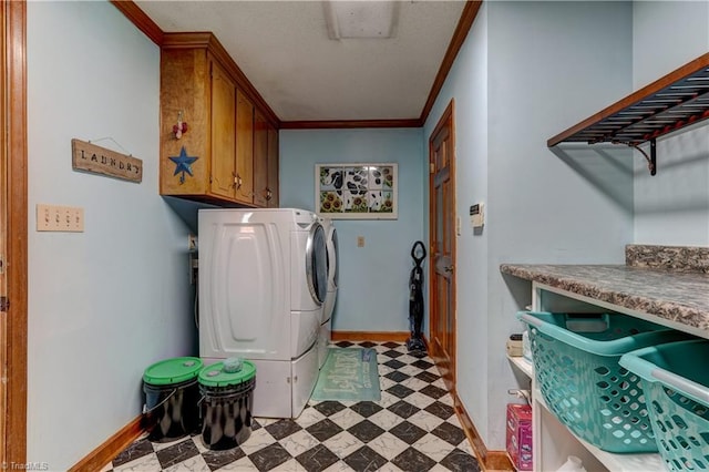 clothes washing area featuring crown molding, cabinets, and independent washer and dryer