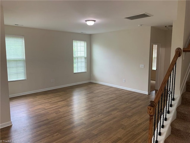 2015 Ram Rd, Greensboro, NC 27405 - unfurnished room featuring dark wood-style flooring and stairway