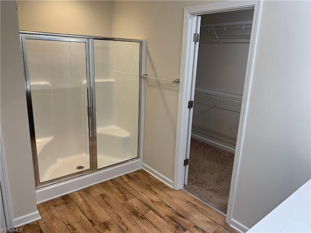 2015 Ram Rd, Greensboro, NC 27405 - bathroom with a shower stall, wood finished floors, and a walk in closet