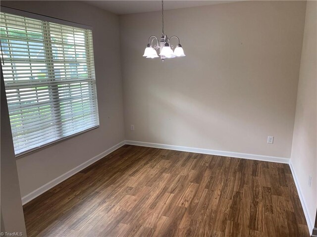 2015 Ram Rd, Greensboro, NC 27405 - empty room with dark wood-style floors and a chandelier