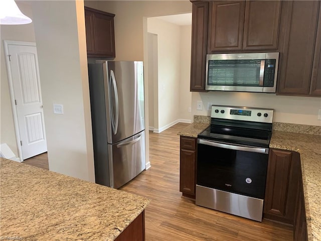 2015 Ram Rd, Greensboro, NC 27405 - kitchen featuring appliances with stainless steel finishes, light wood-style floors, and dark brown cabinetry