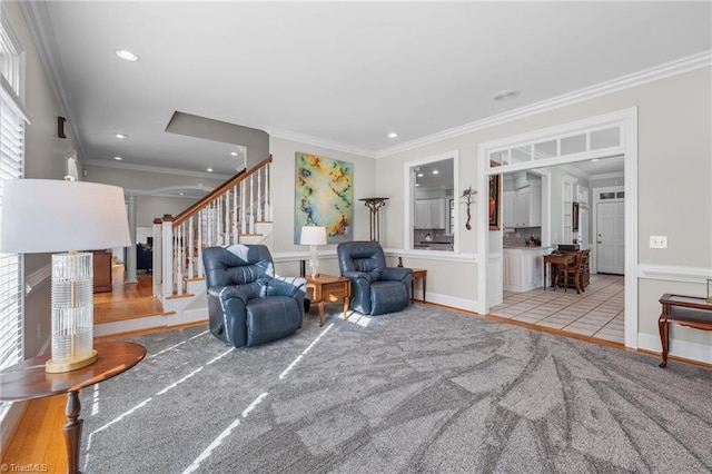 living room with ornamental molding and light hardwood / wood-style floors