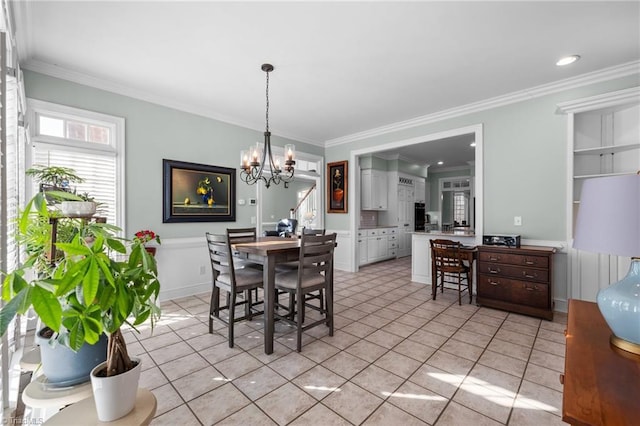 dining space featuring ornamental molding, light tile patterned floors, and a chandelier