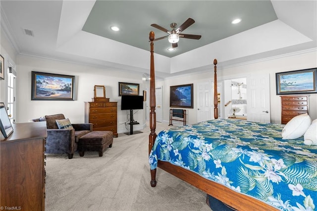 bedroom featuring ornamental molding, light colored carpet, ceiling fan, and a tray ceiling