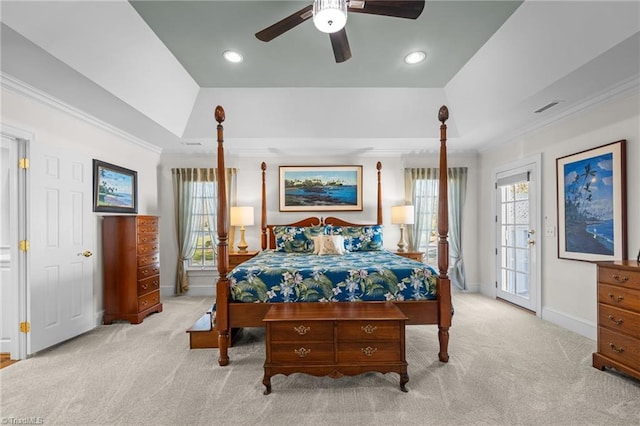 carpeted bedroom featuring multiple windows, access to exterior, crown molding, and a raised ceiling