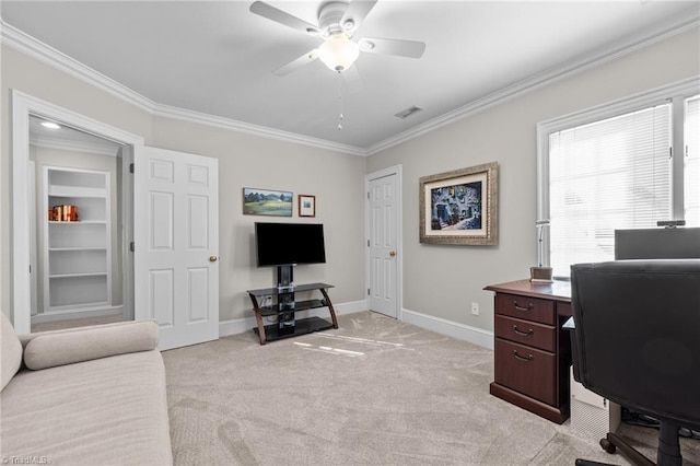 carpeted office space featuring crown molding, built in features, and ceiling fan