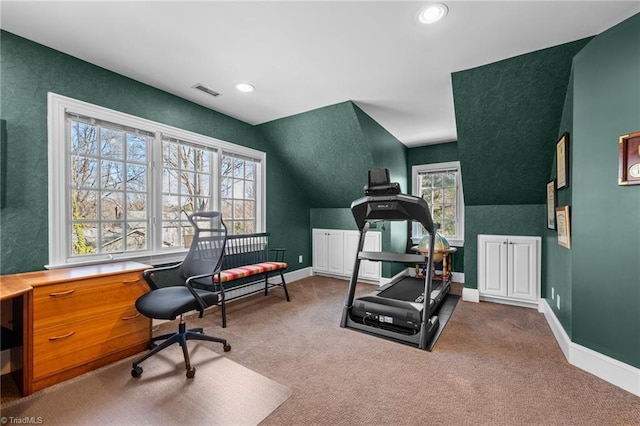 workout room featuring vaulted ceiling and carpet