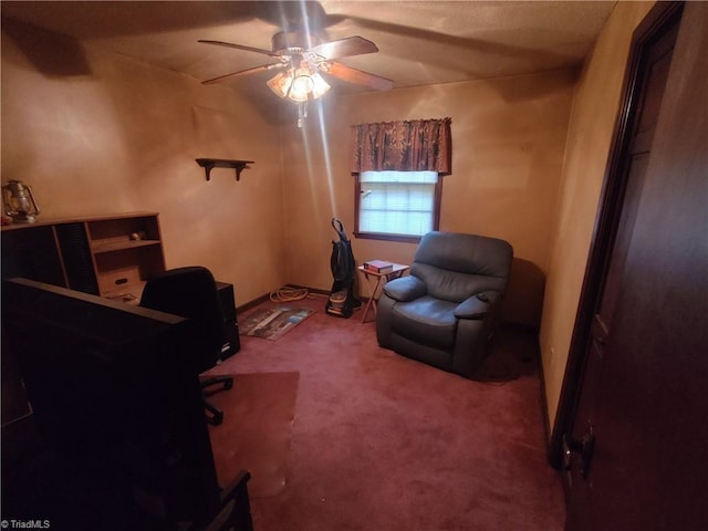 carpeted office space featuring ceiling fan