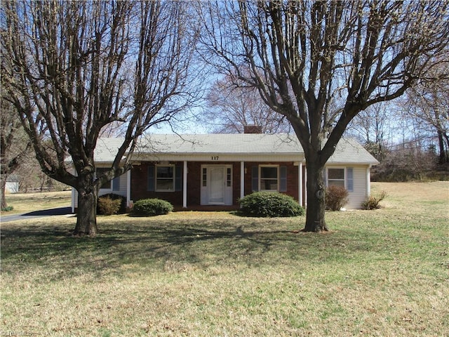 single story home featuring a chimney and a front lawn