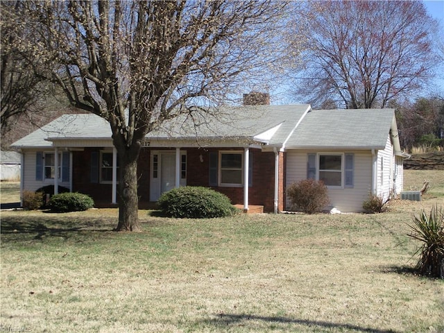 ranch-style home with a chimney and a front lawn