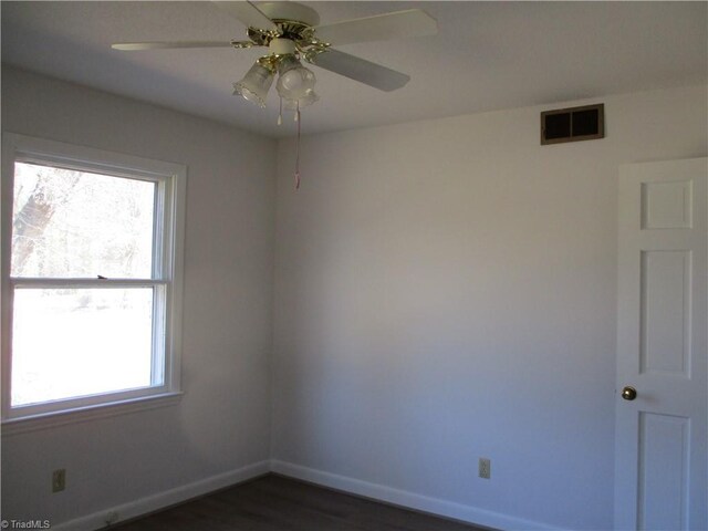 spare room with visible vents, a healthy amount of sunlight, baseboards, and ceiling fan