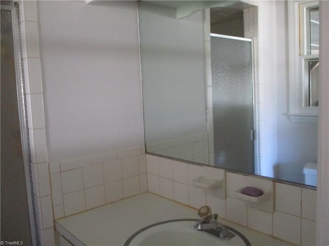 bathroom featuring a shower stall, vanity, and toilet