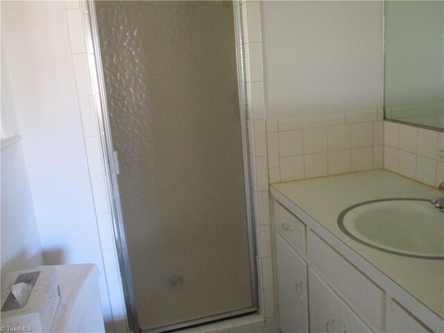 full bath featuring a stall shower and vanity