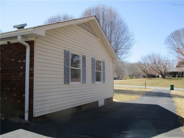 view of side of home featuring brick siding