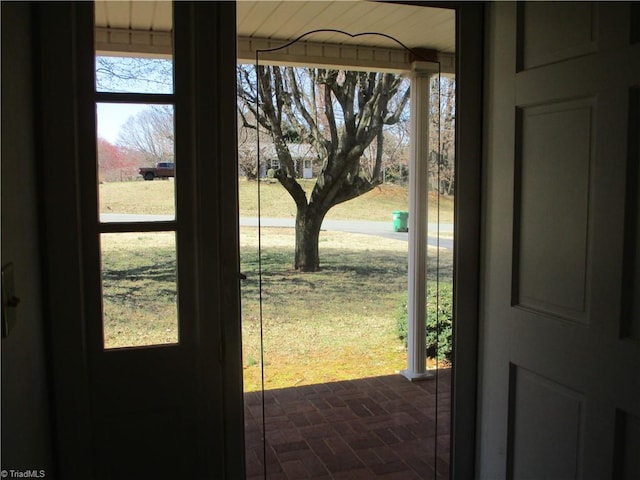 doorway featuring brick floor and a healthy amount of sunlight