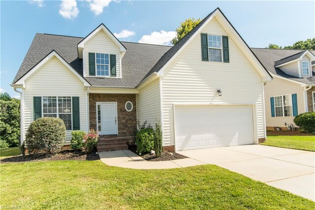 new england style home featuring a garage and a front yard