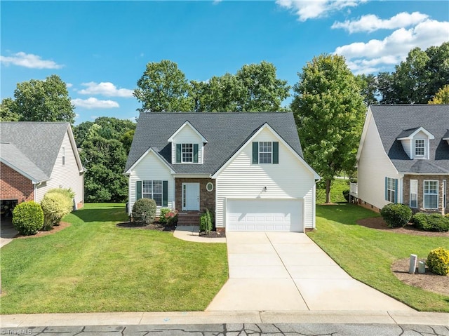 new england style home featuring a front yard and a garage