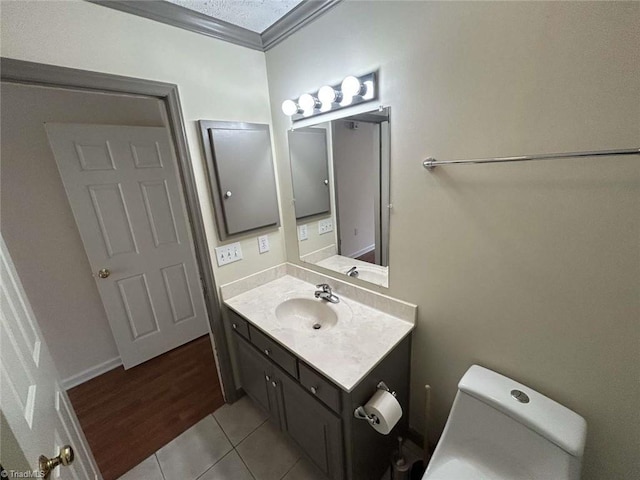 267 S Boyles St, Pilot Mountain, NC 27041 - bathroom featuring vanity, crown molding, tile patterned flooring, and toilet