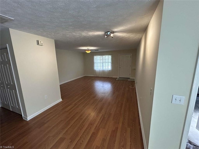 267 S Boyles St, Pilot Mountain, NC 27041 - spare room featuring a textured ceiling, dark wood-type flooring, and baseboards
