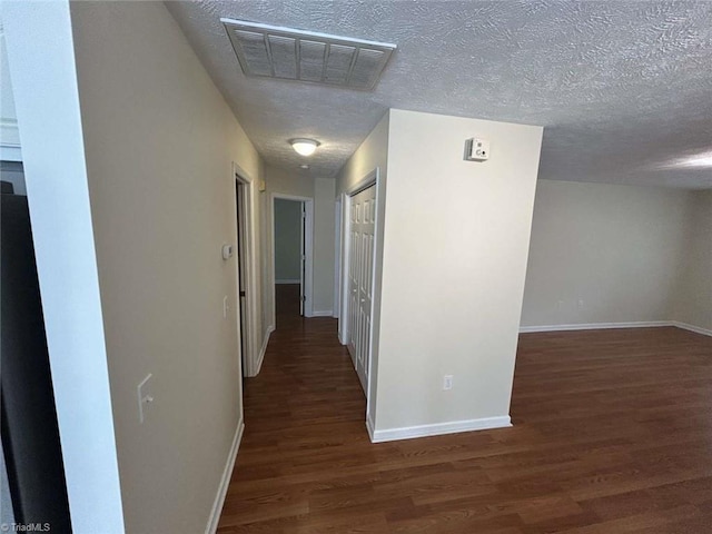 267 S Boyles St, Pilot Mountain, NC 27041 - hallway featuring wood finished floors, baseboards, and a textured ceiling