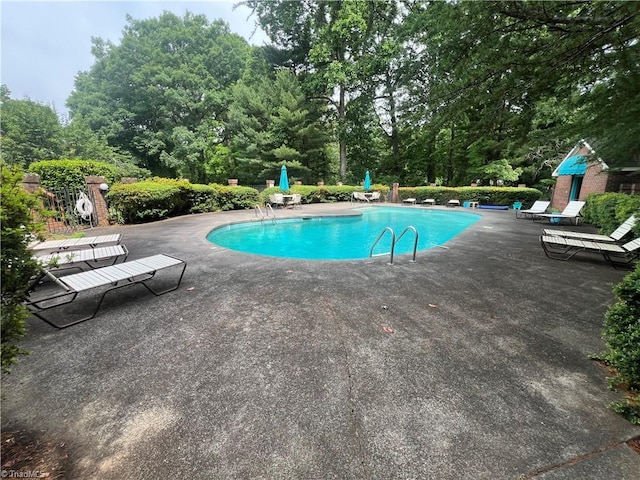 community pool with a patio area