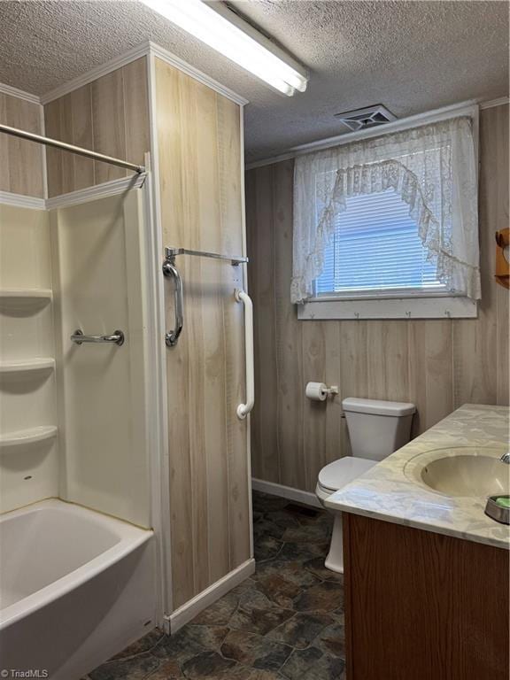 bathroom with visible vents, toilet, a textured ceiling, wood walls, and vanity