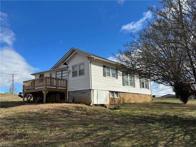 view of property exterior with a lawn and a deck