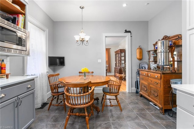 dining room featuring a chandelier, recessed lighting, and baseboards