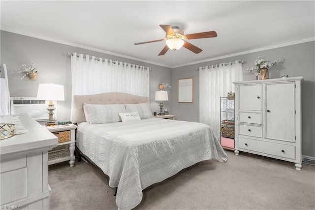 carpeted bedroom featuring ceiling fan and crown molding