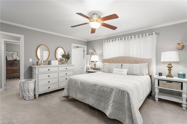 bedroom featuring crown molding, a ceiling fan, and light colored carpet