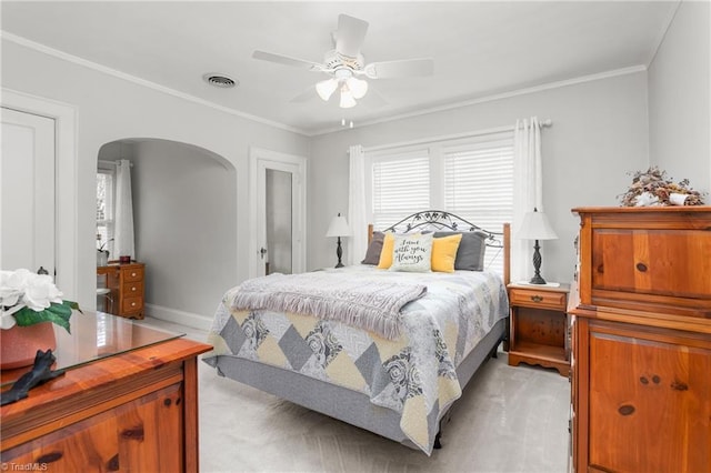 bedroom featuring arched walkways, crown molding, visible vents, a ceiling fan, and baseboards