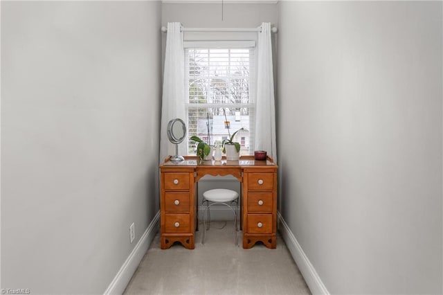 home office with light colored carpet and baseboards