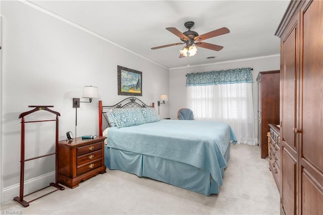 bedroom featuring ceiling fan, baseboards, crown molding, and light colored carpet