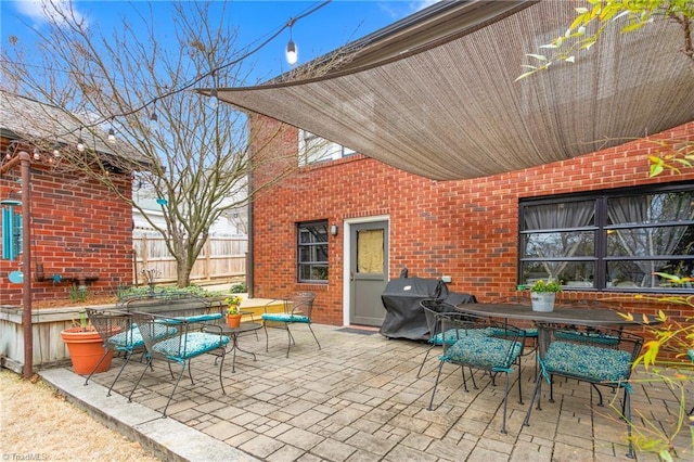 view of patio / terrace with outdoor dining area, fence, and area for grilling