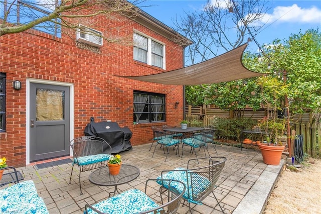 view of patio with fence, outdoor dining area, and area for grilling