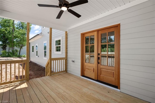 wooden deck with ceiling fan and french doors