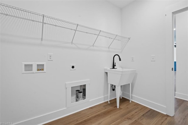 washroom with hookup for a washing machine, hardwood / wood-style flooring, and hookup for an electric dryer