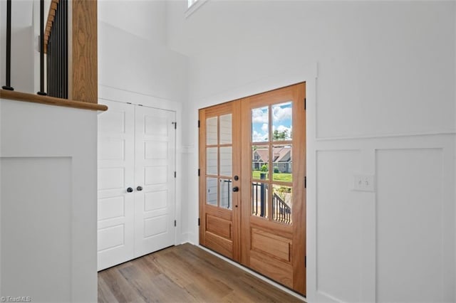 entrance foyer with french doors and light hardwood / wood-style flooring