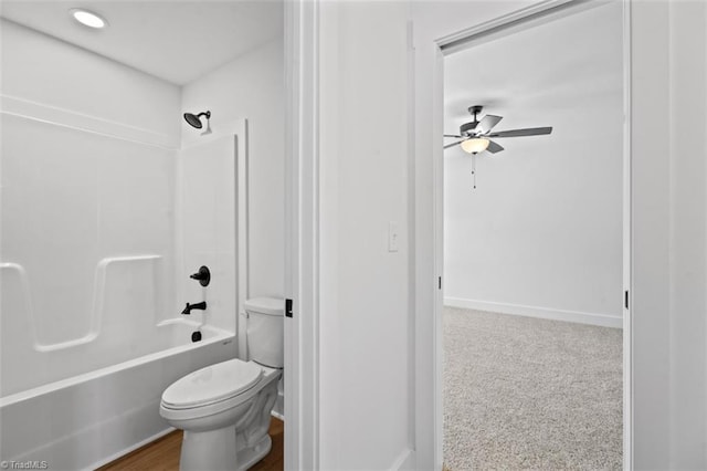 bathroom with toilet, washtub / shower combination, and ceiling fan