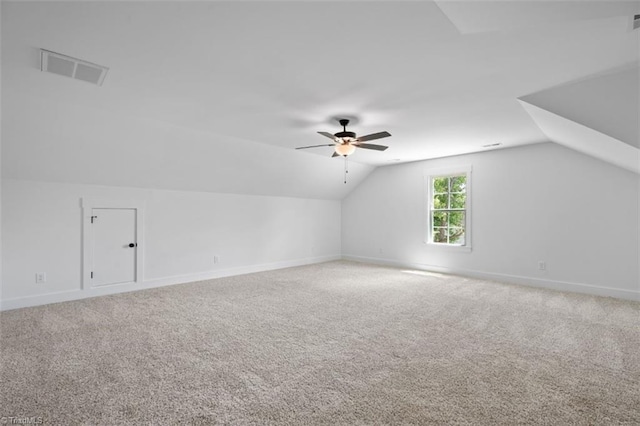 bonus room with vaulted ceiling, carpet flooring, and ceiling fan