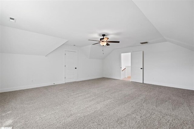 additional living space with carpet floors, lofted ceiling, and ceiling fan