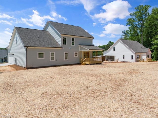 back of house with a deck