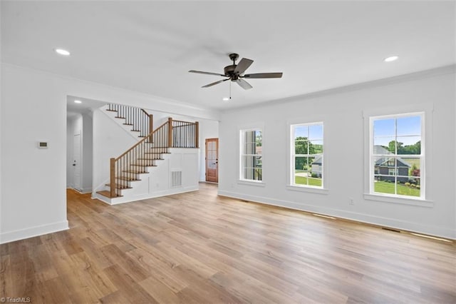 unfurnished living room featuring ornamental molding, light wood-type flooring, and ceiling fan